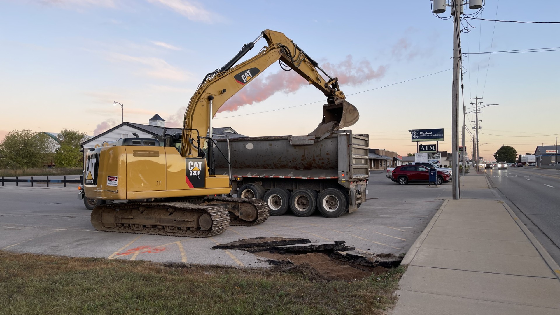 Escavator taking up the concrete of the parking lot.